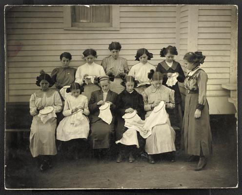 Kentucky students. Back of the photograph reads: Domestic Serivce Class, Dry Creek School, Rowan County, class for embroidery