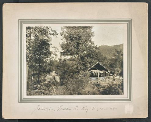 A log cabin, bottom of the photograph reads: Jenkins, Letcher County, Kentucky, 2 years ago
