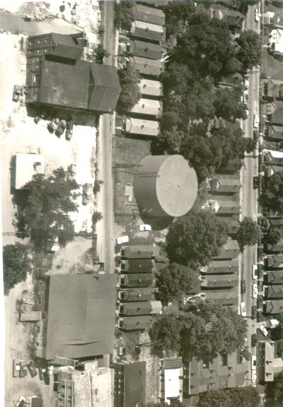 Aerial photographs; Aerial view of a storage tank in a residential area, row housing [MISSING]