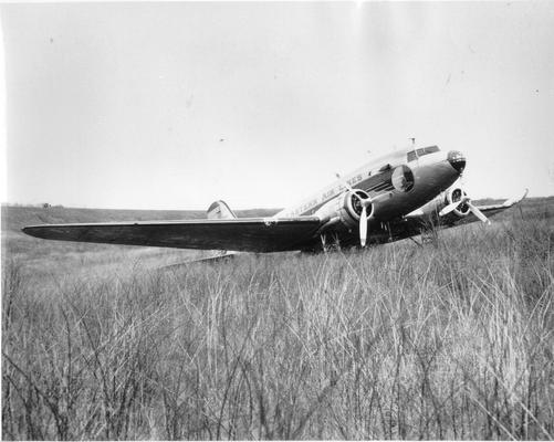 Airplane crashes; Another view of the Eastern Airlines plane in #92 In field, damaged wing