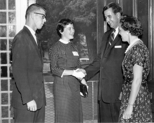 Groups; Unidentified; A young couple being greeted by an older couple