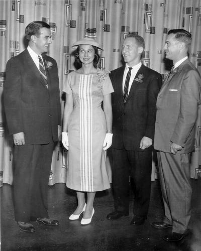 Groups; Unidentified; A woman gets approval on her hat