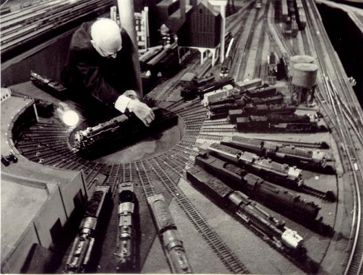 Hatton, Vernon; William W. Haverly inspects his small scale burner engine