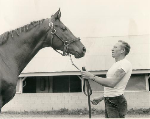 Horse Farms and Owners; Gainesway Farm; Man with large tattoo facing a horse