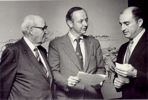 Horse Industry; Unidentified; Three men standing in front of drawing of a horse