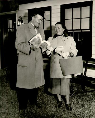 Horse Industry; Unidentified; Couple looking at a Keeneland book