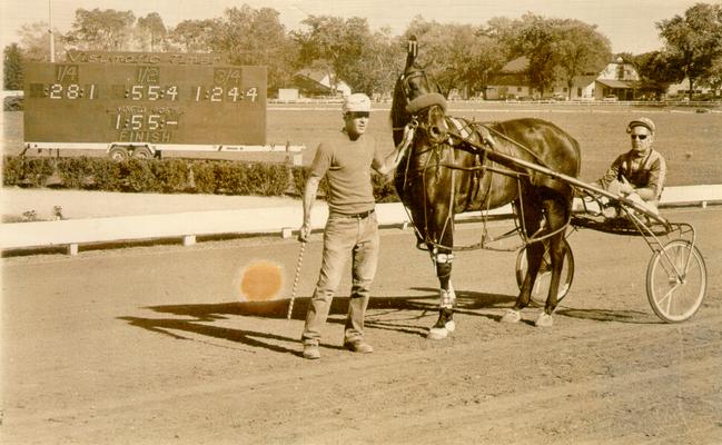 Horses; Harness Racing; Race Scenes; Two men and a horse standing in front of the Visumatic Timer