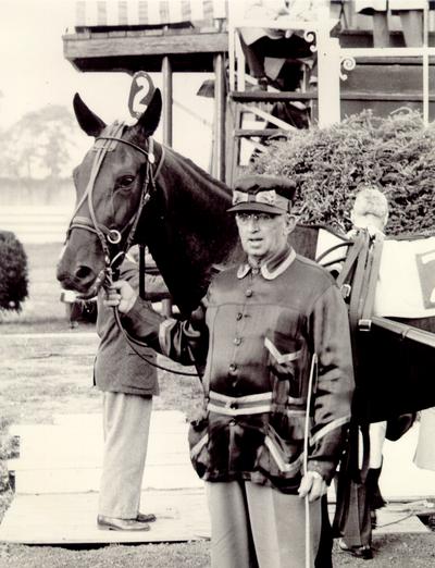 Horses; Harness Racing; Race Scenes; A man in uniform stands beside a horse