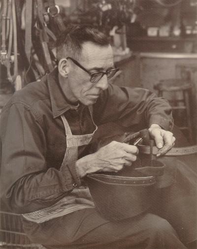 Horses; People Working with Tack and Horse Accessories; Man working with tack