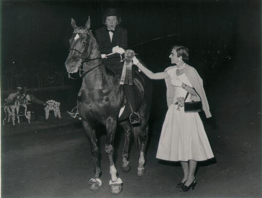 Horses; Show Horses and Jumpers; Woman presenting a ribbon to 