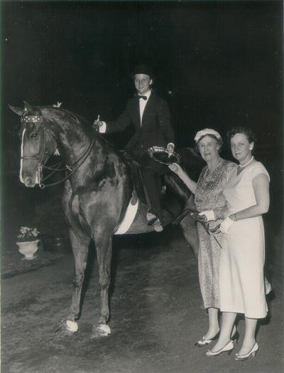 Horses; Show Horses and Jumpers; Two women stand beside a show horse