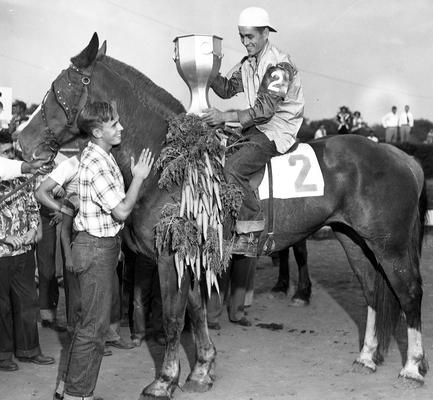 Horses; Thoroughbred Racing; Winner's Circle; A winning horse covered in carrots