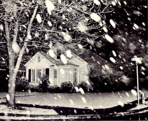 Houses; Unidentified; Snow falls around a house on Sunset Dr