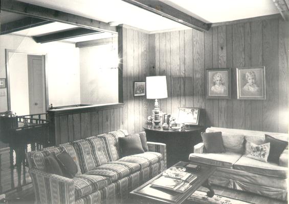 Interiors of Rooms; A living room with two paintings of children on the wall