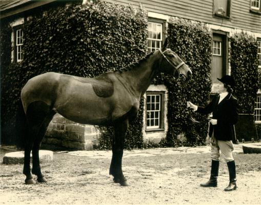 Iroquois Hunt Club; A woman leading her horse