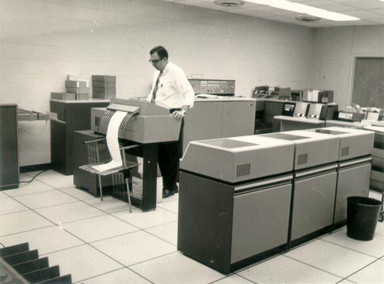 Irvin Industries; A man using a copy machine