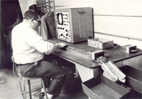 Irvin Industries; A man in glasses assembling components
