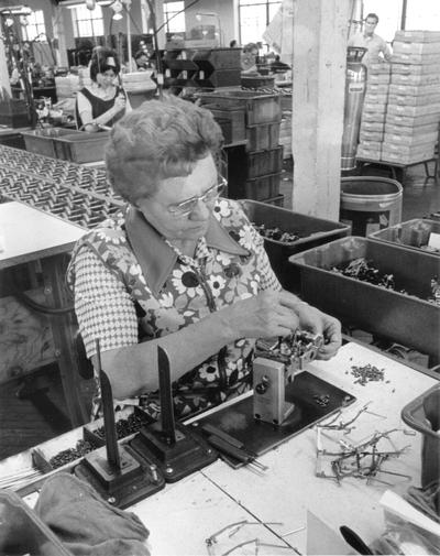 Irvin Industries; A female worker assembling some parts