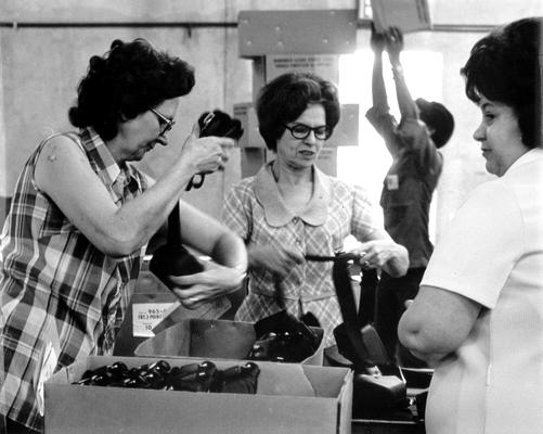 Irvin Industries; Female workers packing boxes