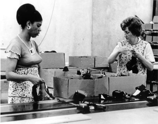 Irvin Industries; Two female workers examining the products