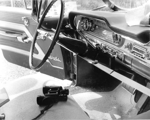 Irvin Industries; Interior of a car with binoculars in the seat