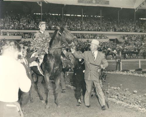 Jones, Ben; Ben Jones leads a horse and jockey