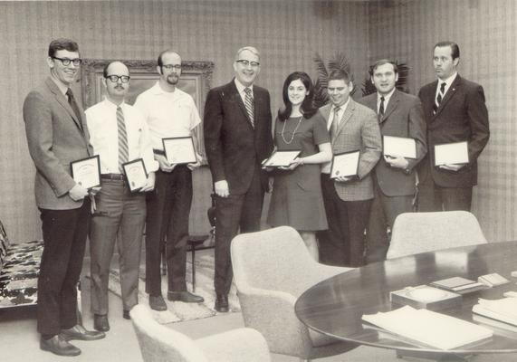 Kentucky Central Life Insurance Company; A group of employees pose holding certificates