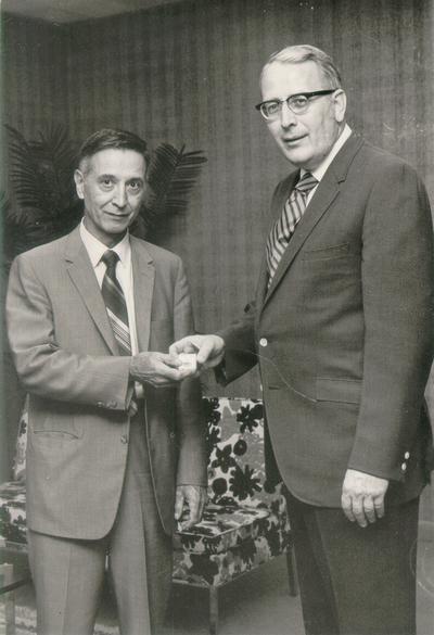 Kentucky Central Life Insurance Company; Two men showing off some jewelry