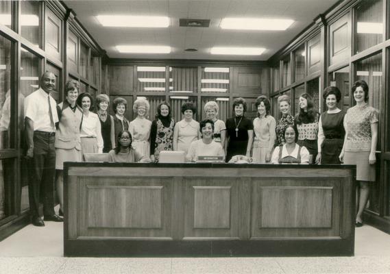 Kentucky Central Life Insurance Company; A group of employees pose behind the information desk