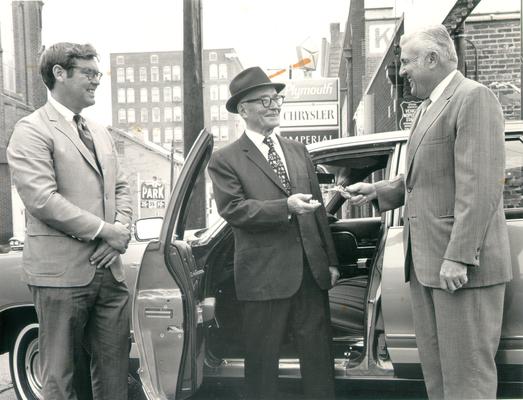 McPheeters, Julian C.; Julian McPheeters, President of Asbury Theological seminary, at a car dealership