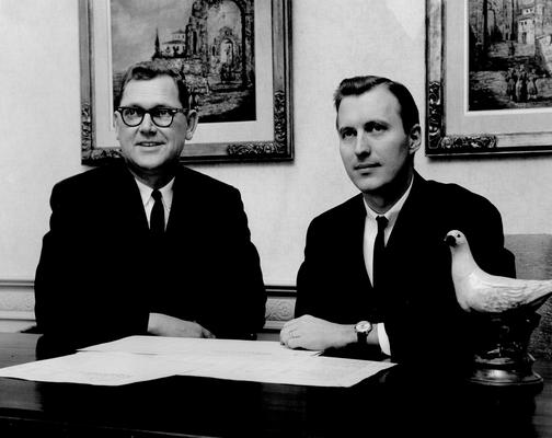 Men; Groups; Unidentified; Two men looking over some documents