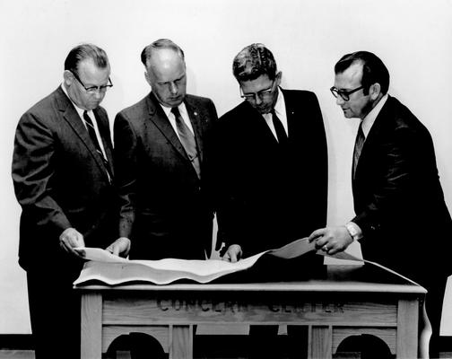 Men; Groups; Unidentified; Four men looking over some blueprints