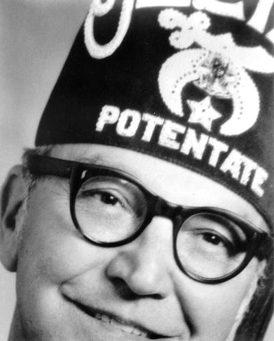 Men; Individual; Unidentified; An extreme close-up of the face of a man wearing glasses and a Masonic hat