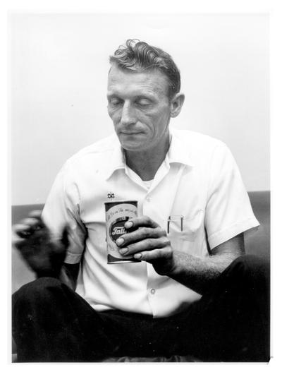 Men; Individual; Unidentified; A man holding a can of Falls City Beer