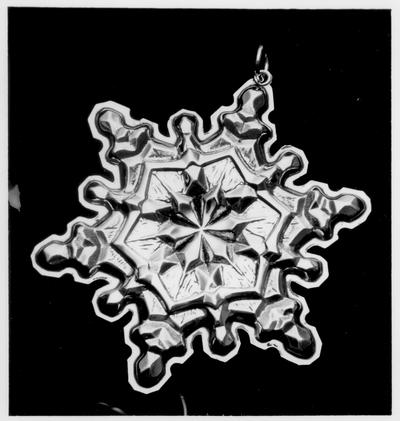 Miscellaneous Objects; A snowflake shaped silver ornament