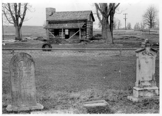 Monuments and Historical Markers; Tombstones in front of a very old cabin