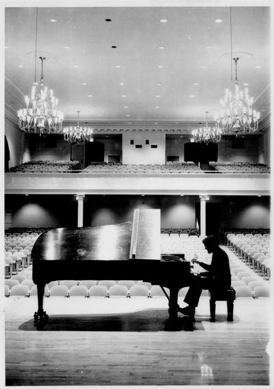 Musicians and Musical Instruments; A piano player practices in an empty concert hall