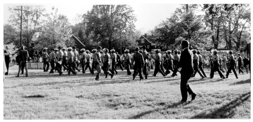 News Photographs; A huge groups of armed policeman gather around a peace rally