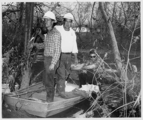 News Photographs; Unhappy-looking men in a small boat