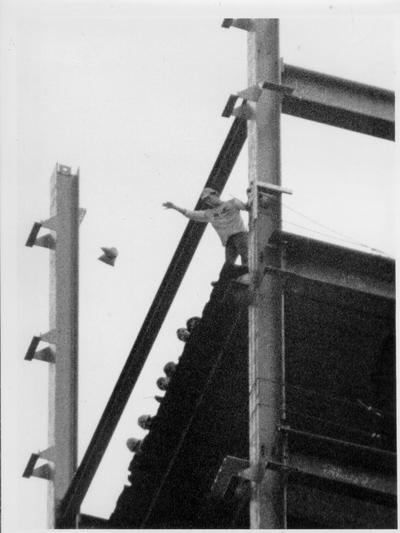 News Photographs; A very blurry shot of a man throwing something off of a bridge