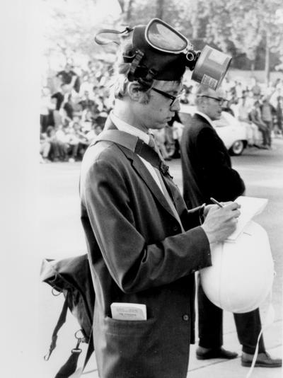 News Photographs; A reporter wearing riot gear