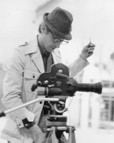 Photographers; A video photographer setting up his equipment