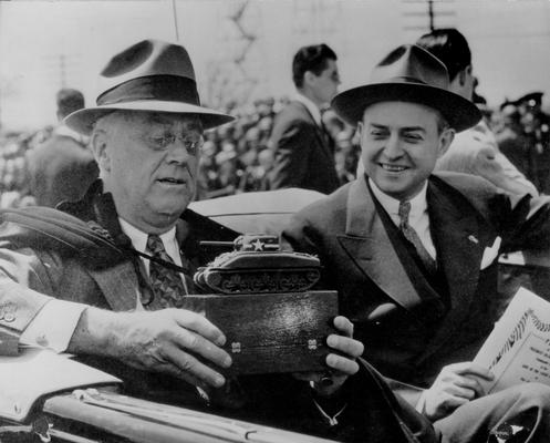 Roosevelt, Franklin D.; Roosevelt and Keen Johnson look at a toy tank