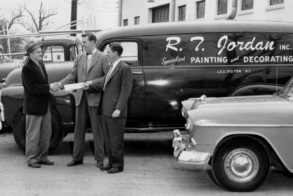 Jordan, R.T. Inc.; Men shaking hands beside an R.T. Jordan truck