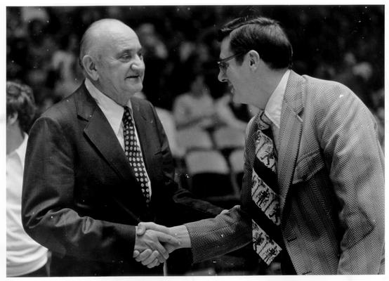 Rupp, Adolph F.; Rupp shakes hand with Joe B. Hall