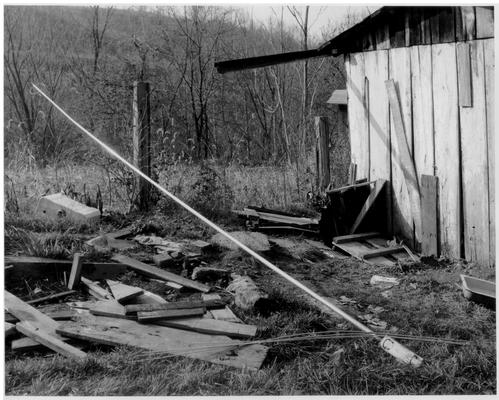 Rural Scenes; A tool shed, surrounded by debris