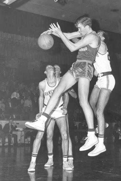 Transylvania University; Basketball; A Madonna player attempts a wrap-around pass in mid-air