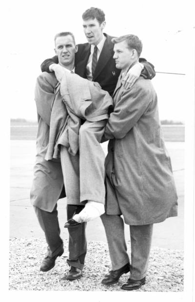University of Kentucky; Basketball; Two young men carry a wounded man (Burrow, Grawmeyer, Bird)