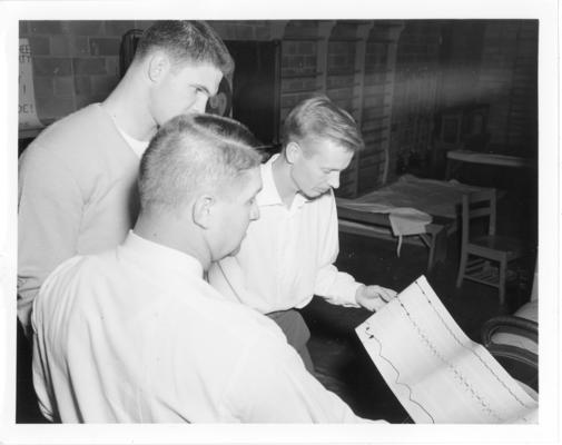 University of Kentucky; Basketball; Three man looking at a chart