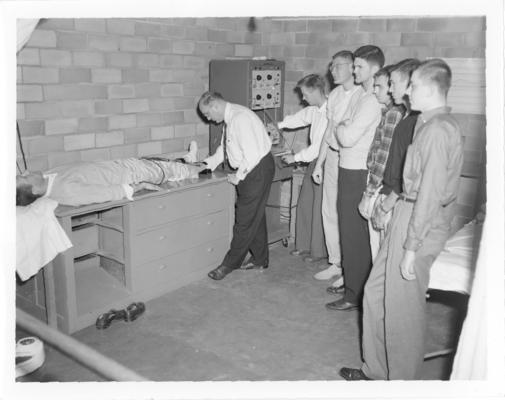 University of Kentucky; Basketball; Boys look on as a doctor examines a patient